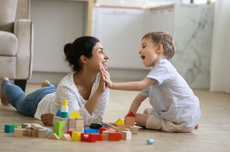 Nanny and young child with building blocks